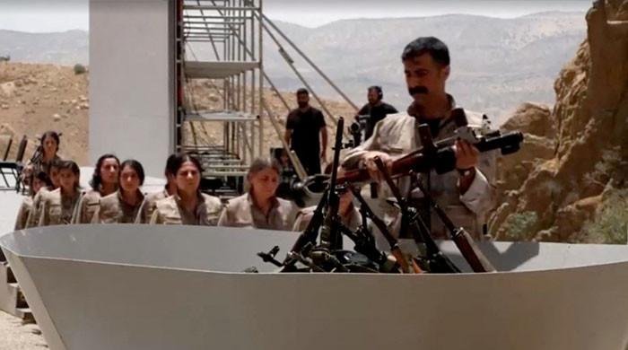 Kurdish PKK militants burn weapons in Iraq to launch disarmament