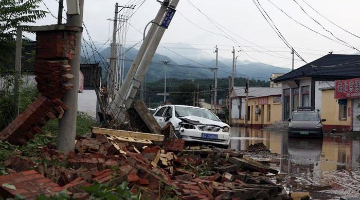 China floods leave 30 dead, tens of thousands forced to flee