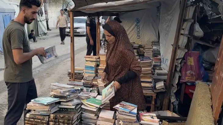 Gaza woman rescues books from rubble to keep education alive